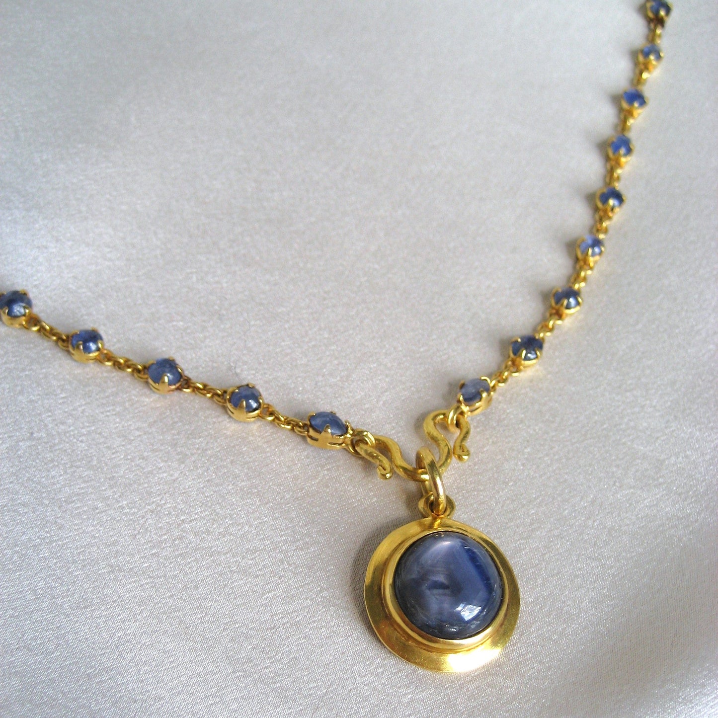 20k gold sapphire cabochon bezel set pendant and matching chain with small oval cabochon sapphires in tiny prongs