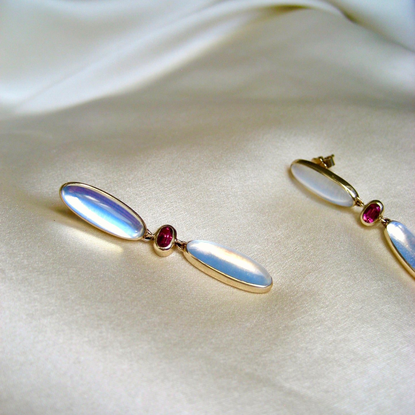 A pair of oval statement drop earrings with oval moonstones and pink tourmalines