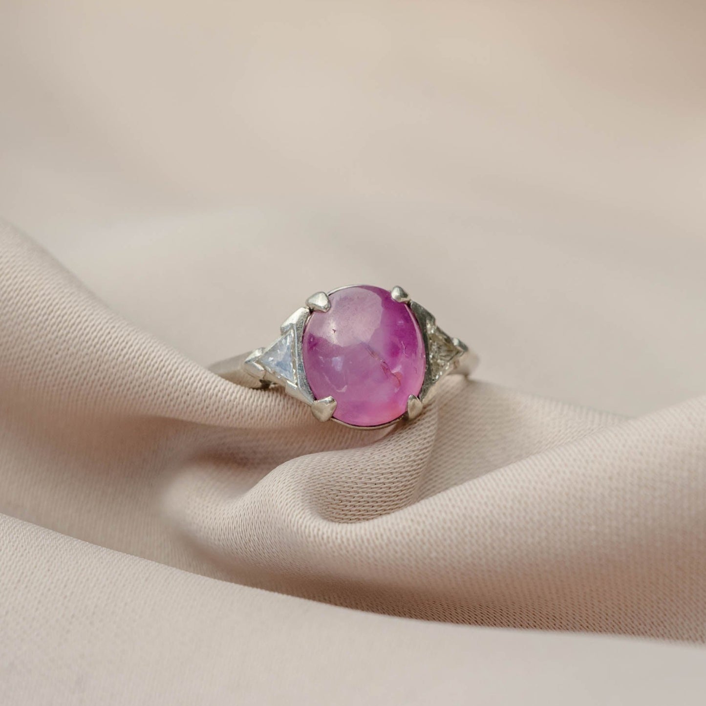 Cabochon Oval Pink Sapphire Platinum Ring with Trillion Cut Diamonds